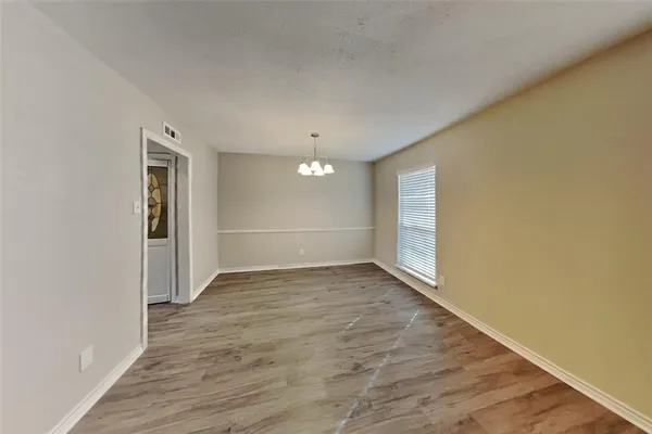 a view of an empty room and wooden floor