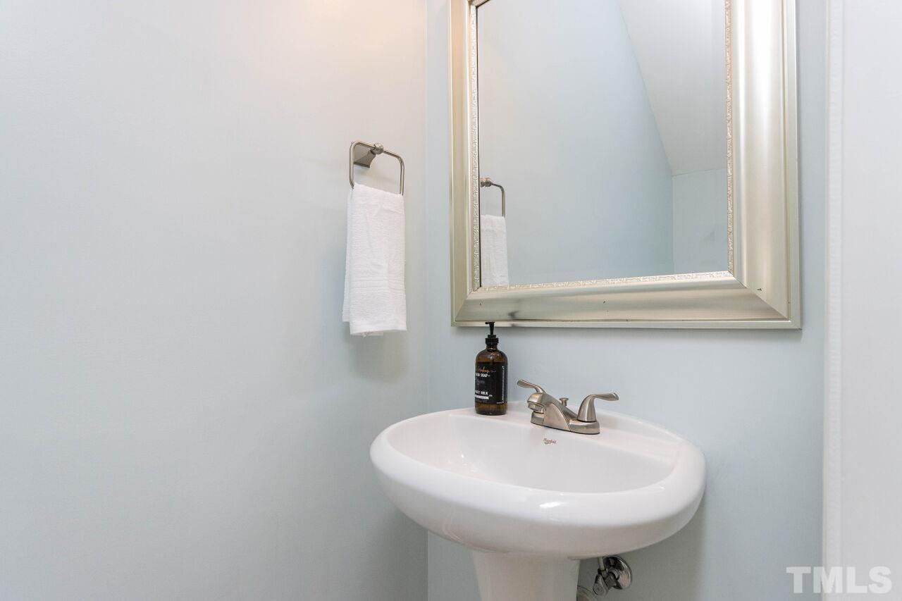 7863 Spungold Street Raleigh, NC 27617 - Photo 14 of 34 a bathroom with a sink and a mirror