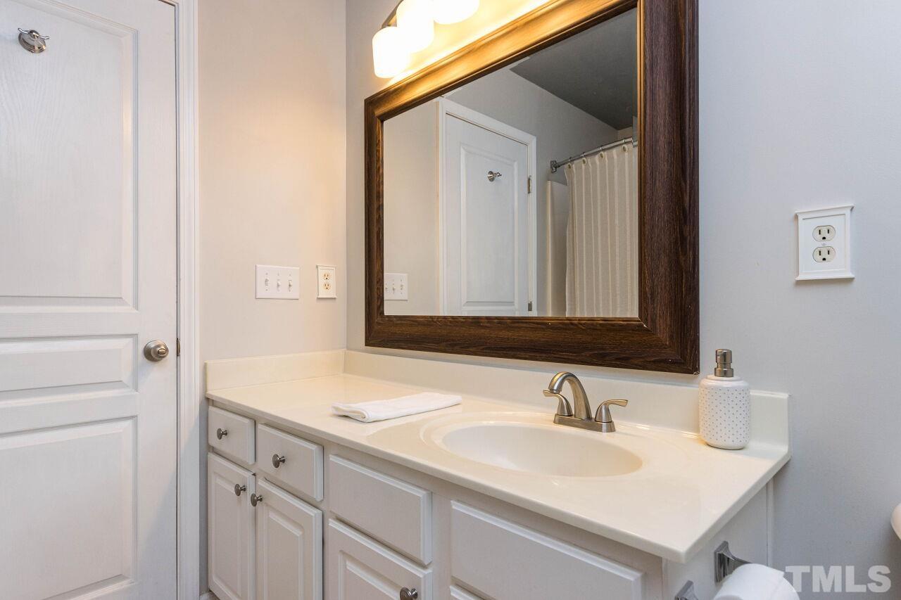 7863 Spungold Street Raleigh, NC 27617 - Photo 18 of 34 a bathroom with a sink and a mirror