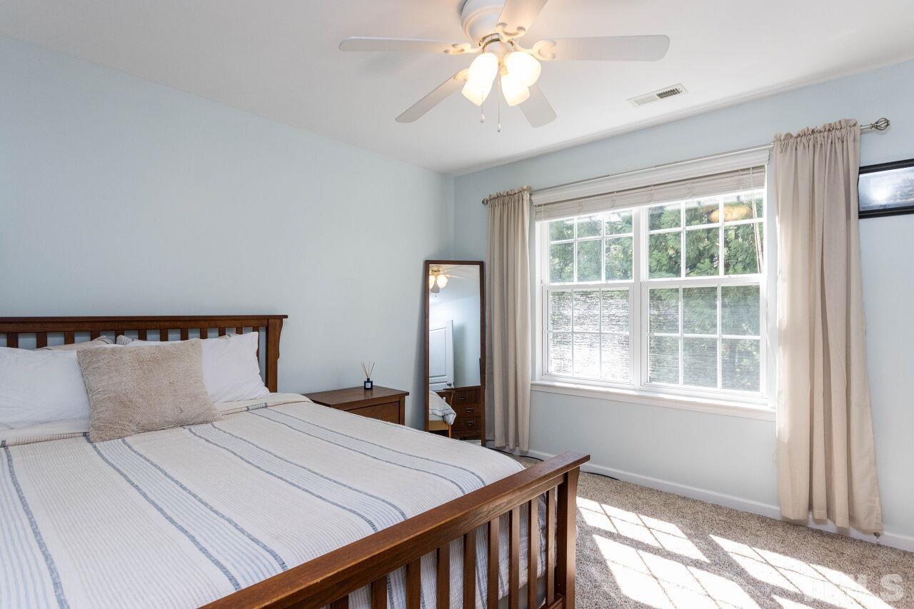 7863 Spungold Street Raleigh, NC 27617 - Photo 20 of 34 a bedroom with a large bed and a window