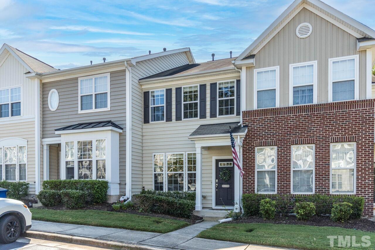7863 Spungold Street Raleigh, NC 27617 - Photo 2 of 34 front view of a brick house with a yard
