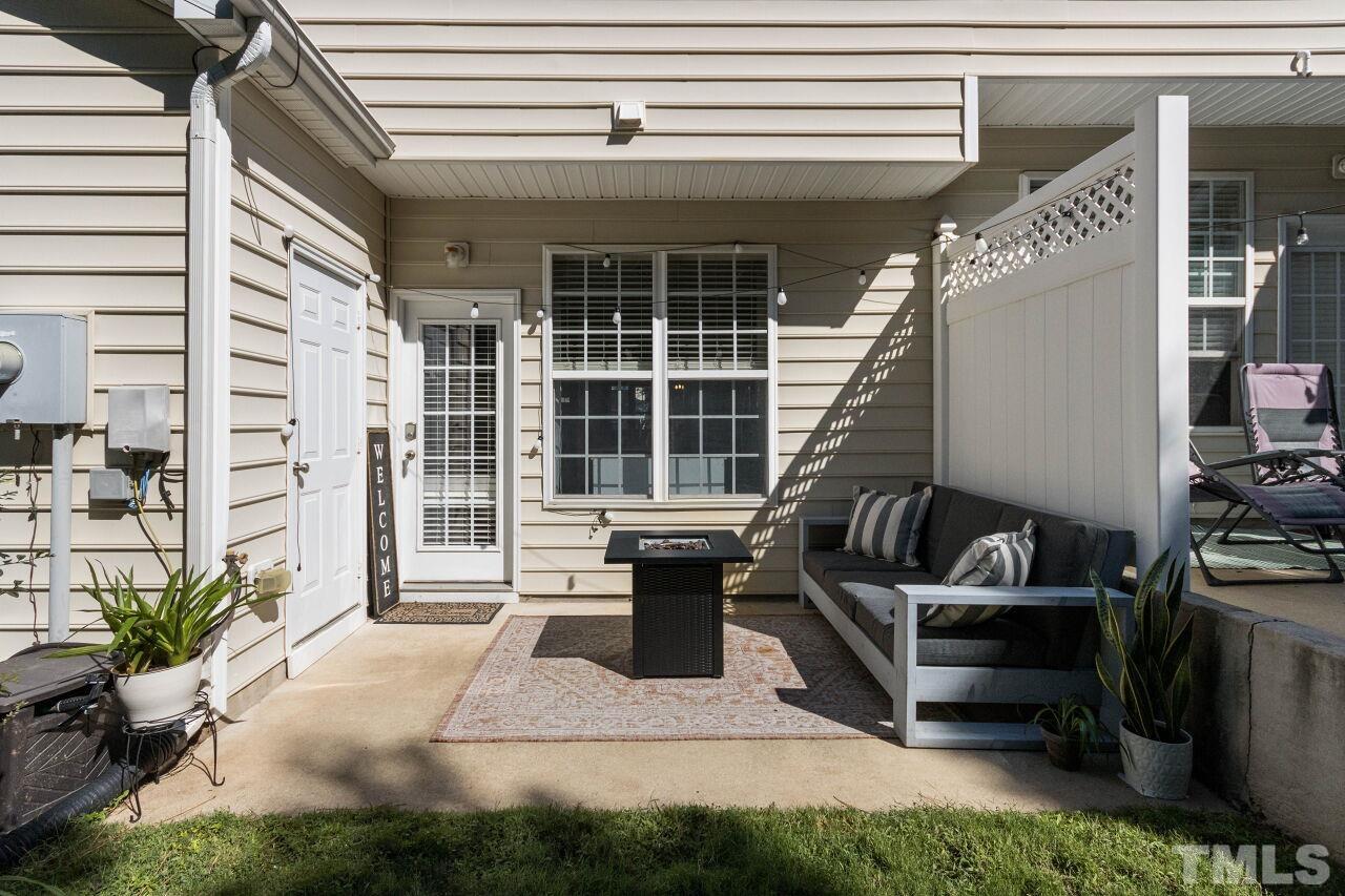 7863 Spungold Street Raleigh, NC 27617 - Photo 25 of 34 a view of a patio with couches chairs and potted plants