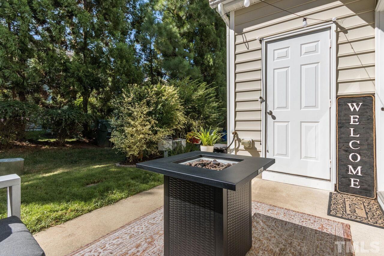 7863 Spungold Street Raleigh, NC 27617 - Photo 26 of 34 a table and chairs in front of a door