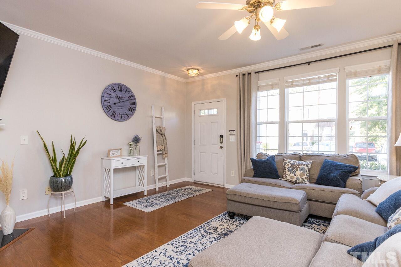 7863 Spungold Street Raleigh, NC 27617 - Photo 5 of 34 a living room with furniture and wooden floor