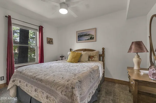 a bedroom with bed and window