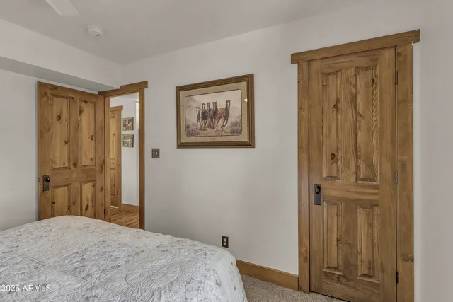 a bedroom with a bed and hallway