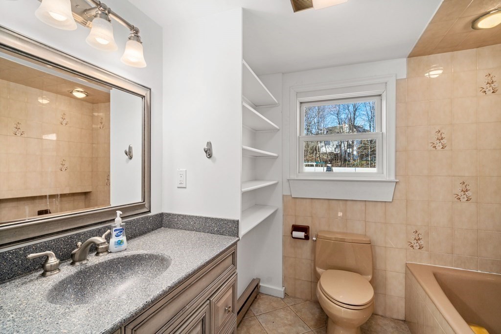3 Old English Road Worcester, MA 01609 - Photo 22 of 36 a bathroom with a granite countertop toilet sink and mirror
