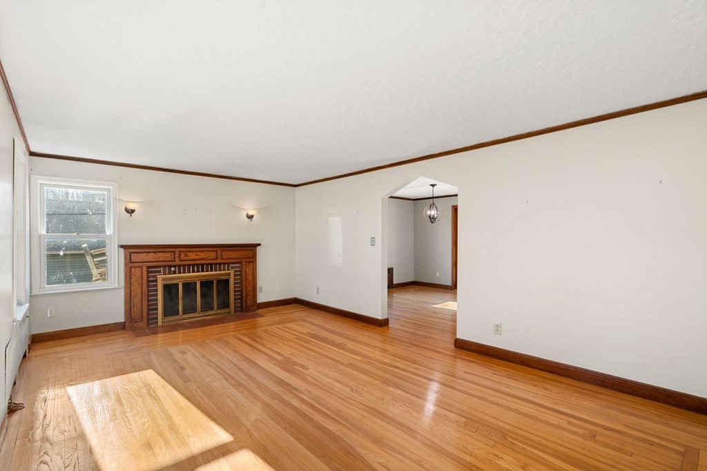 3 Old English Road Worcester, MA 01609 - Photo 5 of 36 a view of an empty room with wooden floor fireplace and a window