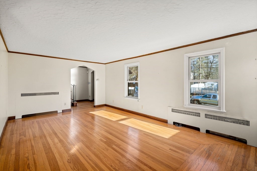 3 Old English Road Worcester, MA 01609 - Photo 6 of 36 a view of an empty room with wooden floor and a window