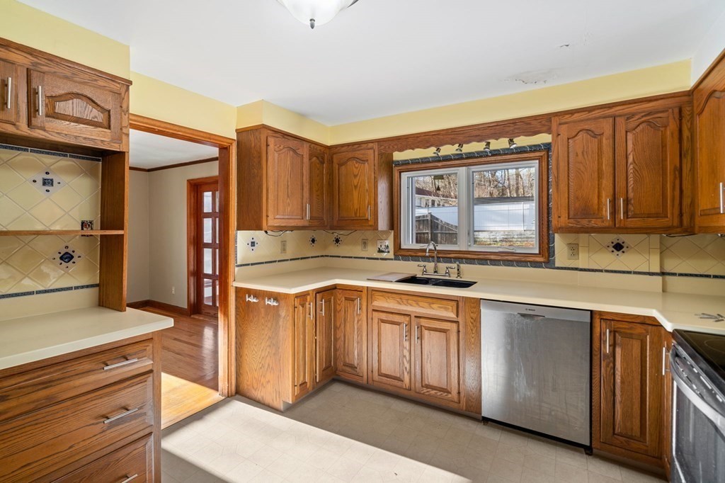 3 Old English Road Worcester, MA 01609 - Photo 9 of 36 a kitchen with stainless steel appliances granite countertop a sink and cabinets