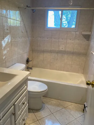 a bathroom with a sink a toilet and bathtub
