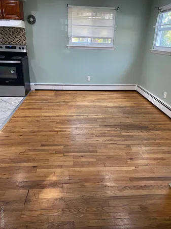 a view of a room with wooden floor and a fireplace
