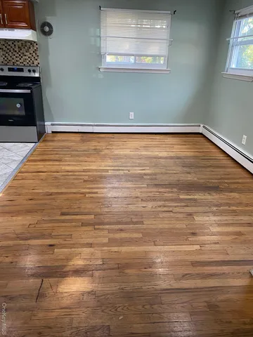 a view of a room with wooden floor and a fireplace