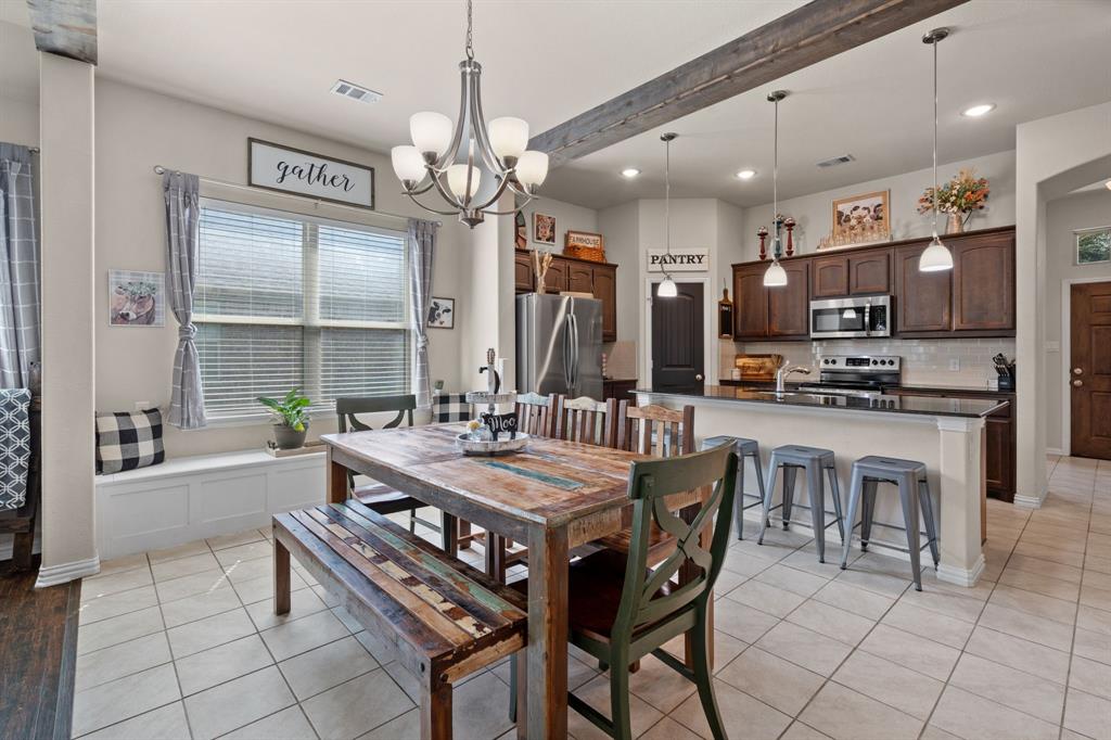 a large kitchen with a table and chairs