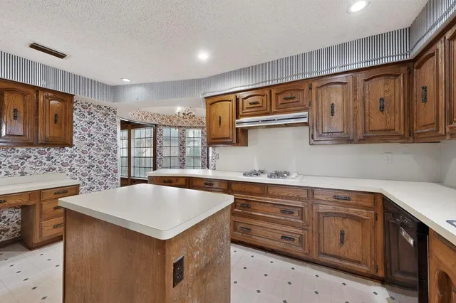 a kitchen that has a sink and a stove in it
