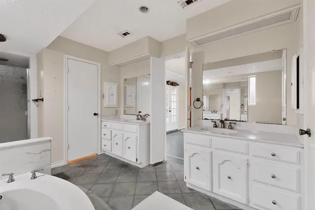 a spacious bathroom with a granite countertop sink mirror and