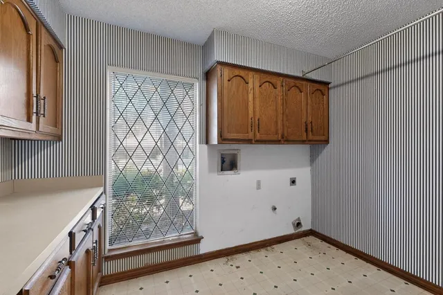 a view of a room with wooden floor and cabinet