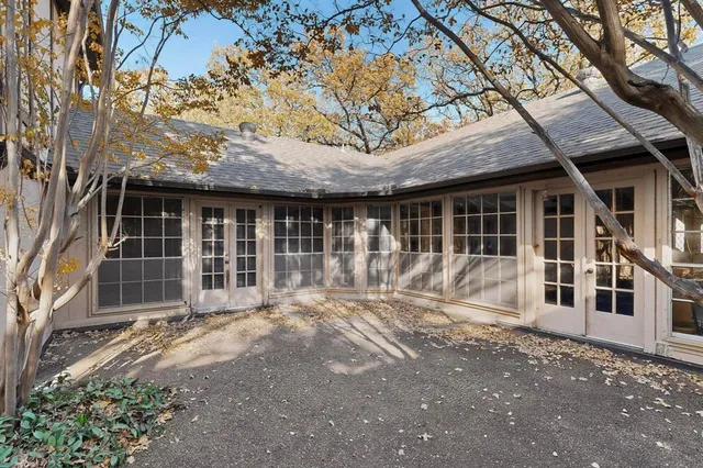 a view of a house with a large window and wooden fence