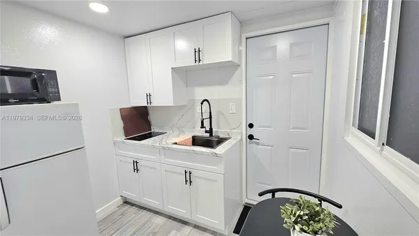 a kitchen with a sink and a refrigerator