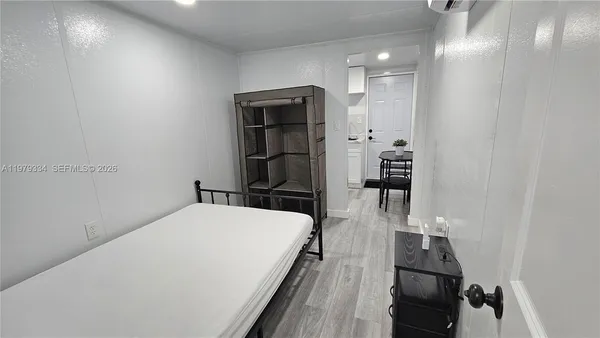 a view of a living room with furniture and wooden floor