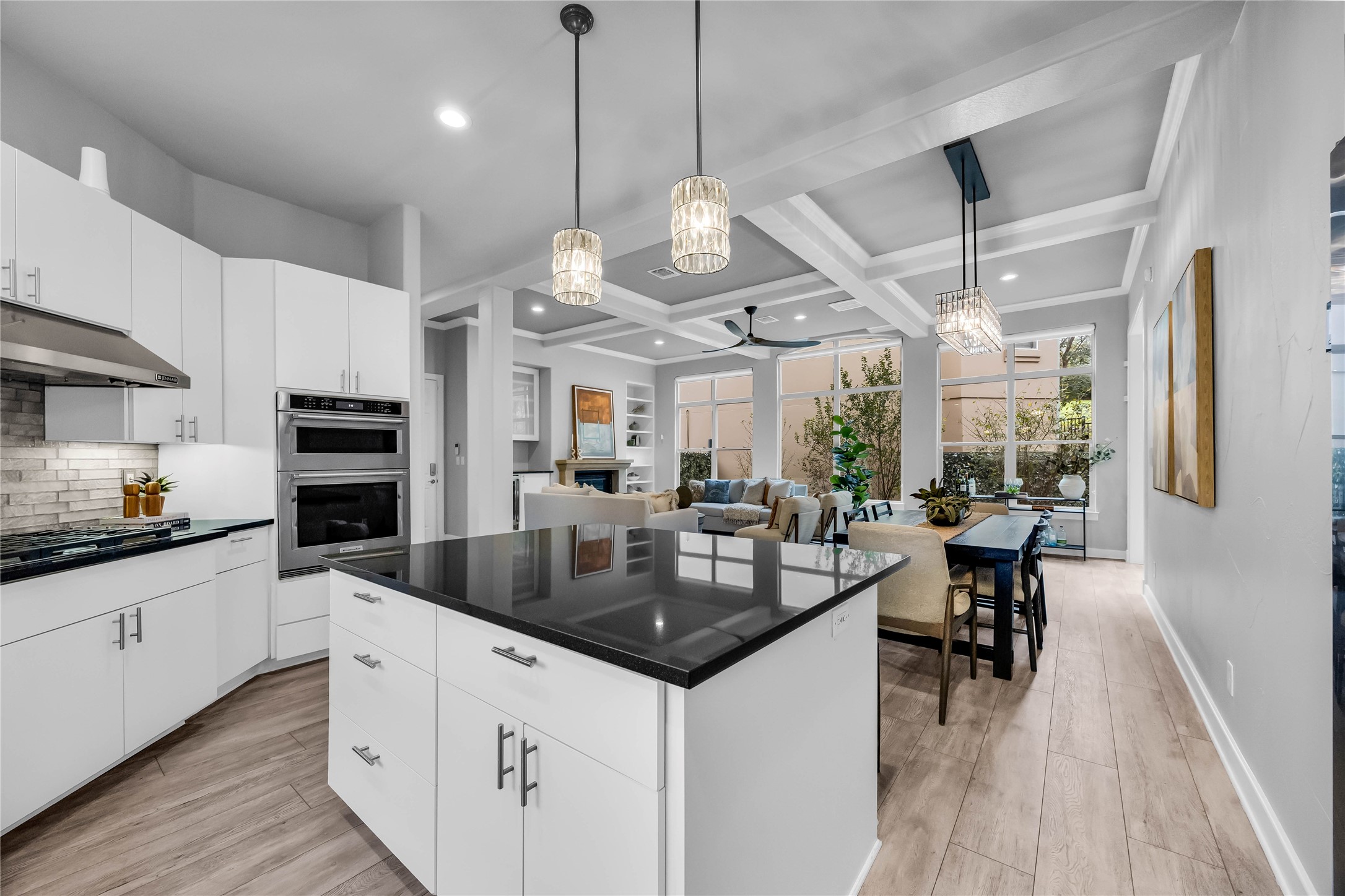 2800 Waymaker Way, Unit 36 Austin, TX 78746 - Photo 11 of 40 a kitchen with stainless steel appliances granite countertop a sink a stove and a wooden floors