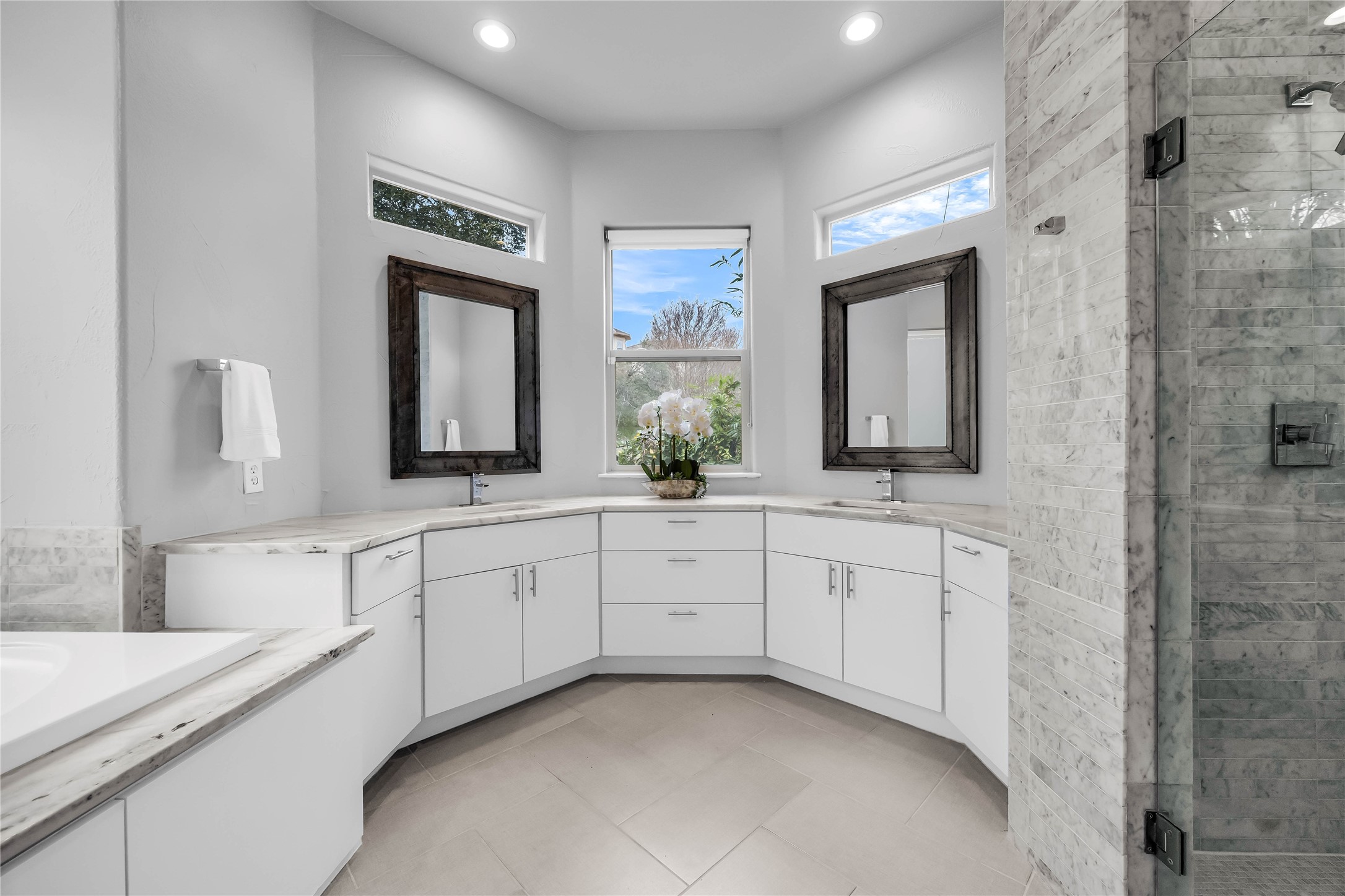 2800 Waymaker Way, Unit 36 Austin, TX 78746 - Photo 25 of 40 a spacious bathroom with a double vanity sink and a mirror