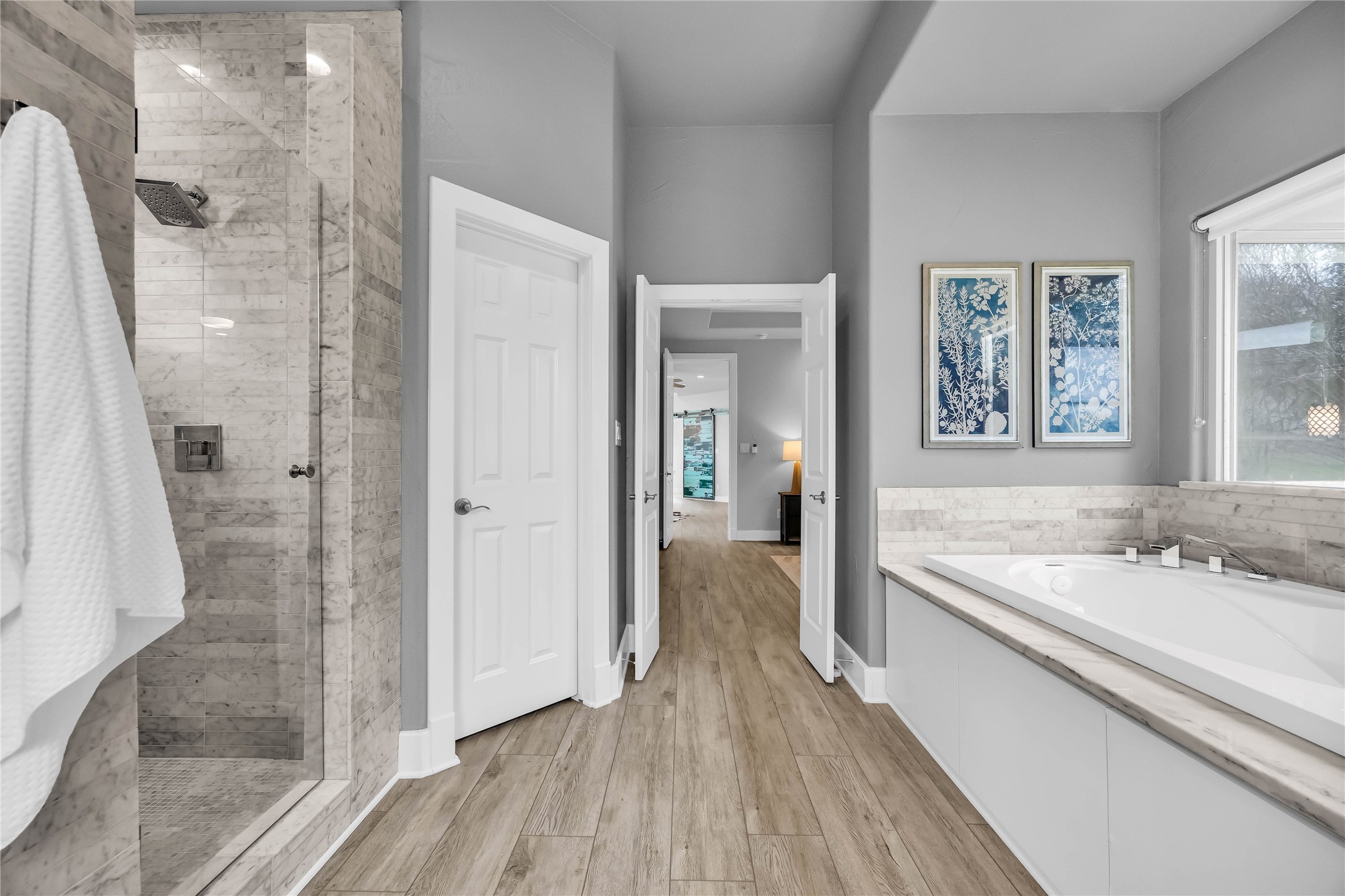 2800 Waymaker Way, Unit 36 Austin, TX 78746 - Photo 27 of 40 a bathroom with a granite countertop shower a mirror and a sink