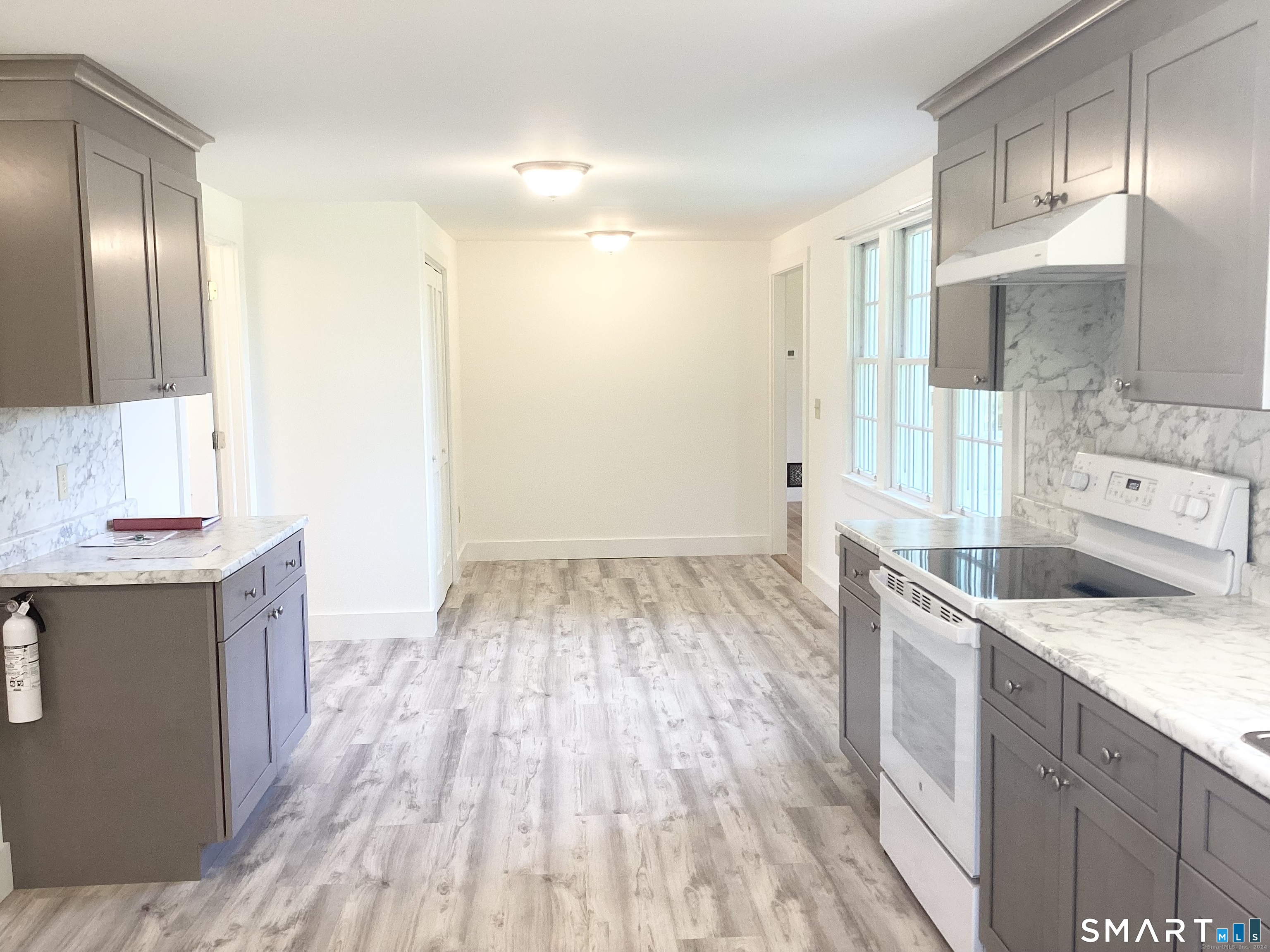 533 Weekeepeemee Road Woodbury, CT 06798 - Photo 13 of 17 a view of a kitchen island wooden floor and staircase