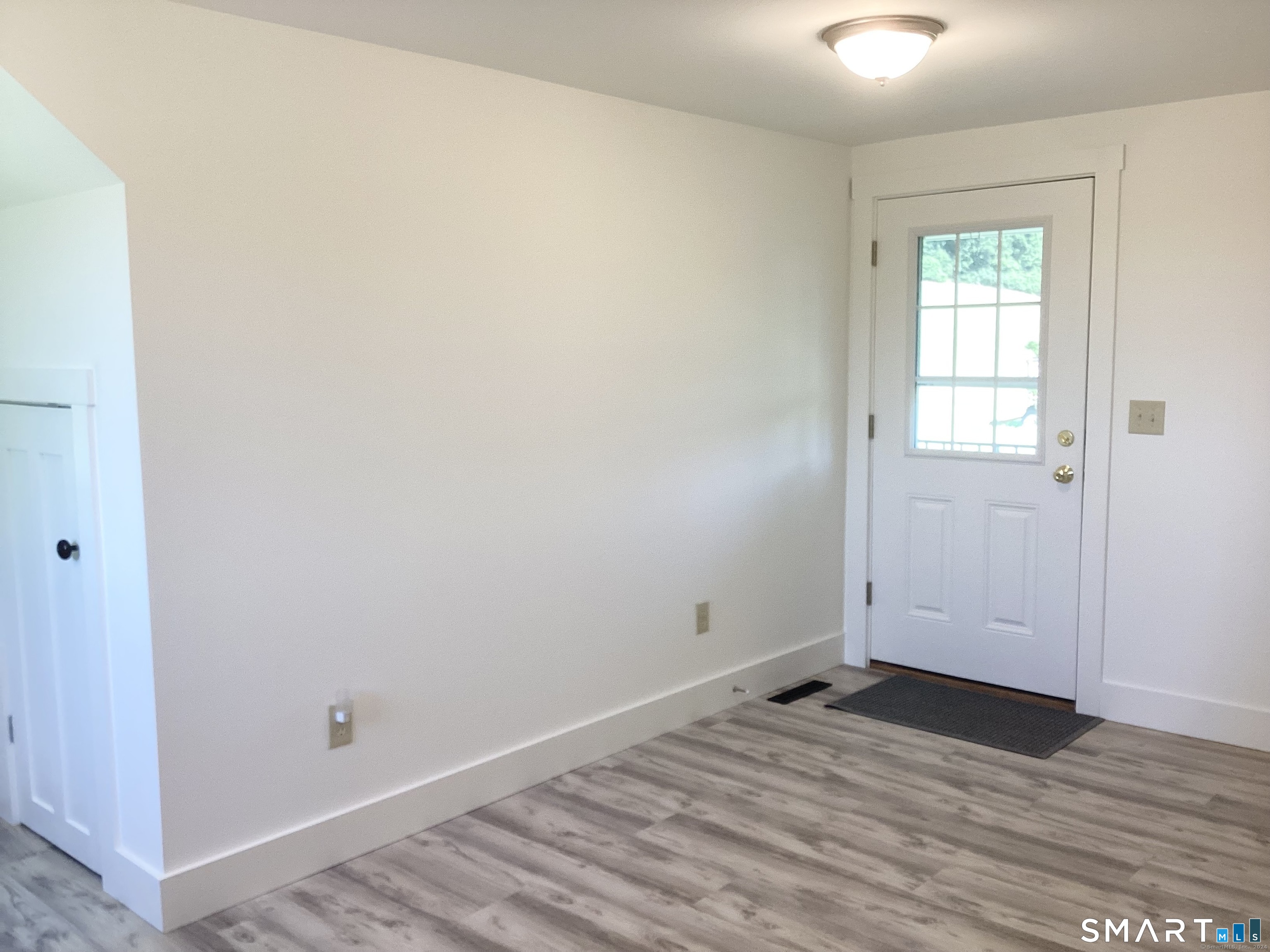 533 Weekeepeemee Road Woodbury, CT 06798 - Photo 15 of 17 an empty room with wooden floor and windows