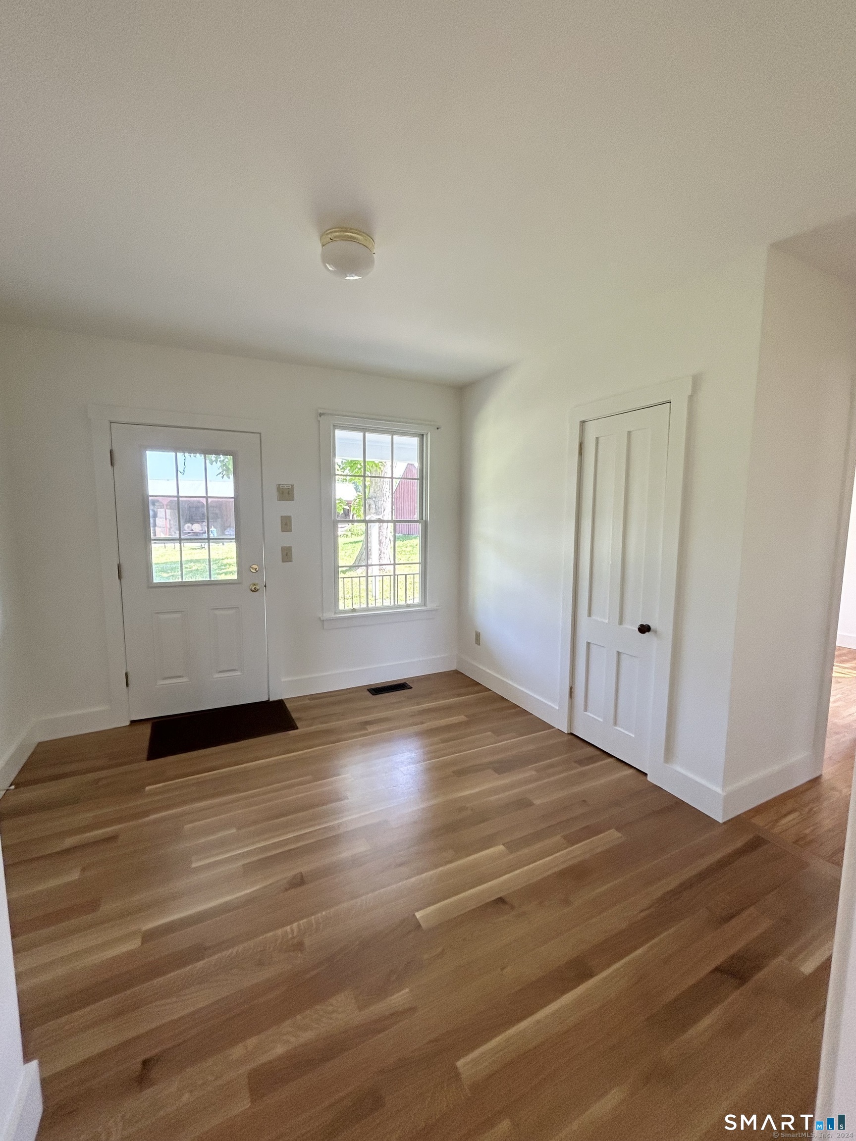 533 Weekeepeemee Road Woodbury, CT 06798 - Photo 6 of 17 an empty room with wooden floor and windows