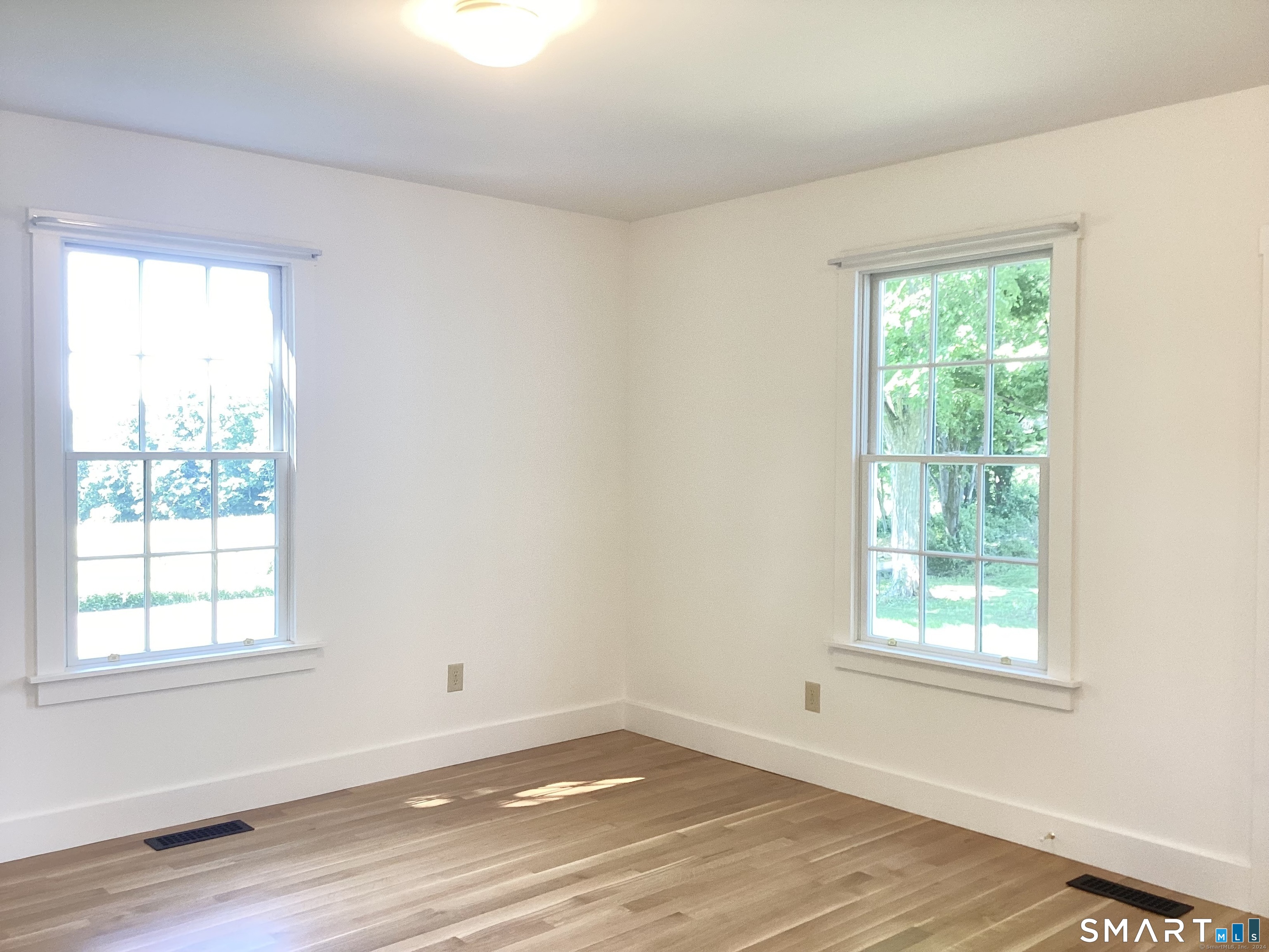 533 Weekeepeemee Road Woodbury, CT 06798 - Photo 7 of 17 a view of a big room with wooden floor and windows in it