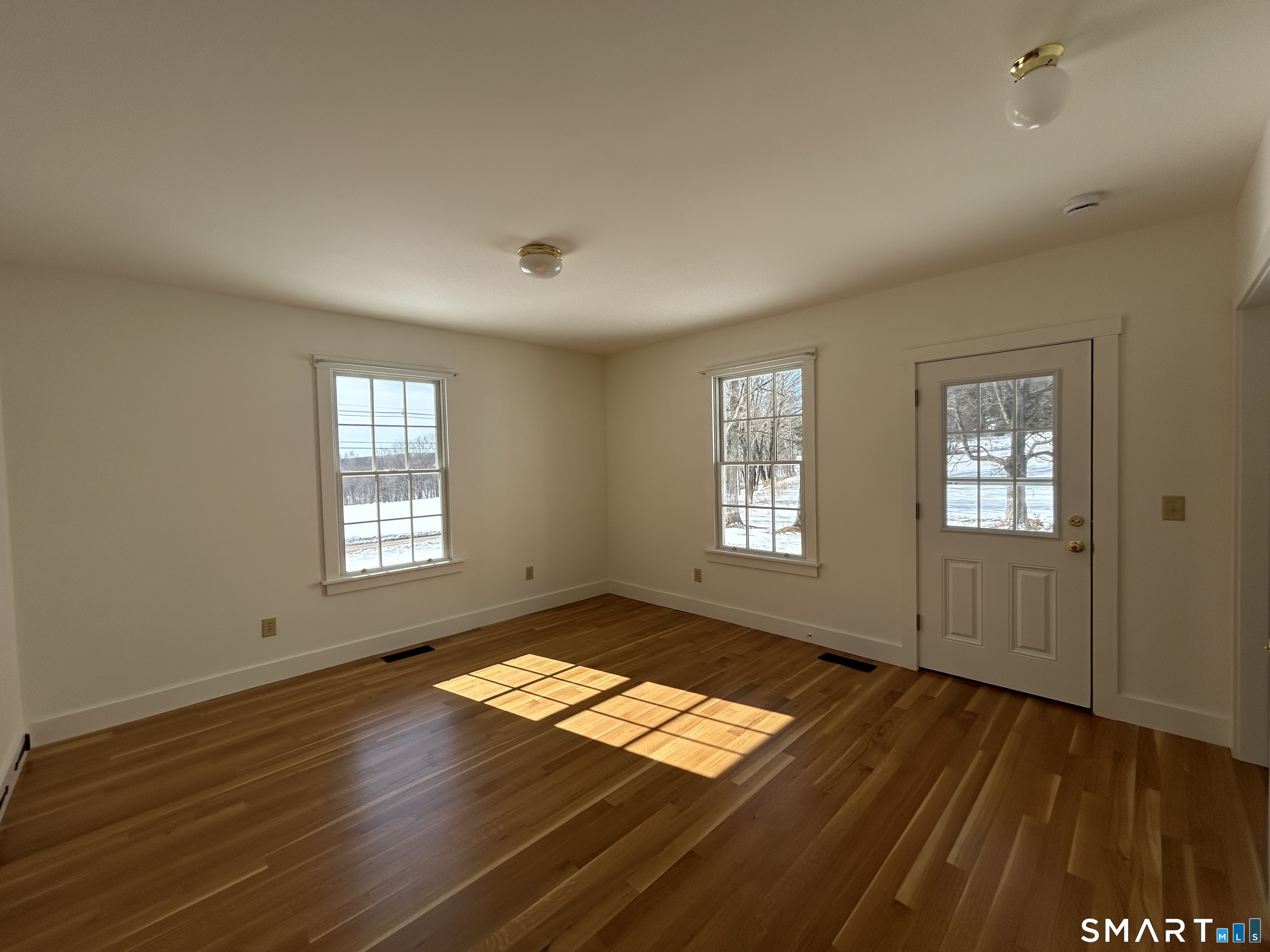 533 Weekeepeemee Road Woodbury, CT 06798 - Photo 9 of 17 a view of empty room with wooden floor and fan