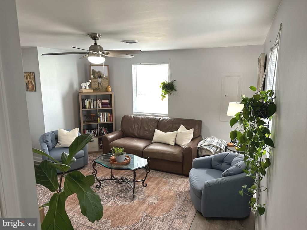 7703 Dover Road Glen Burnie, MD 21060 - Photo 7 of 25 a living room with furniture potted plant and a window