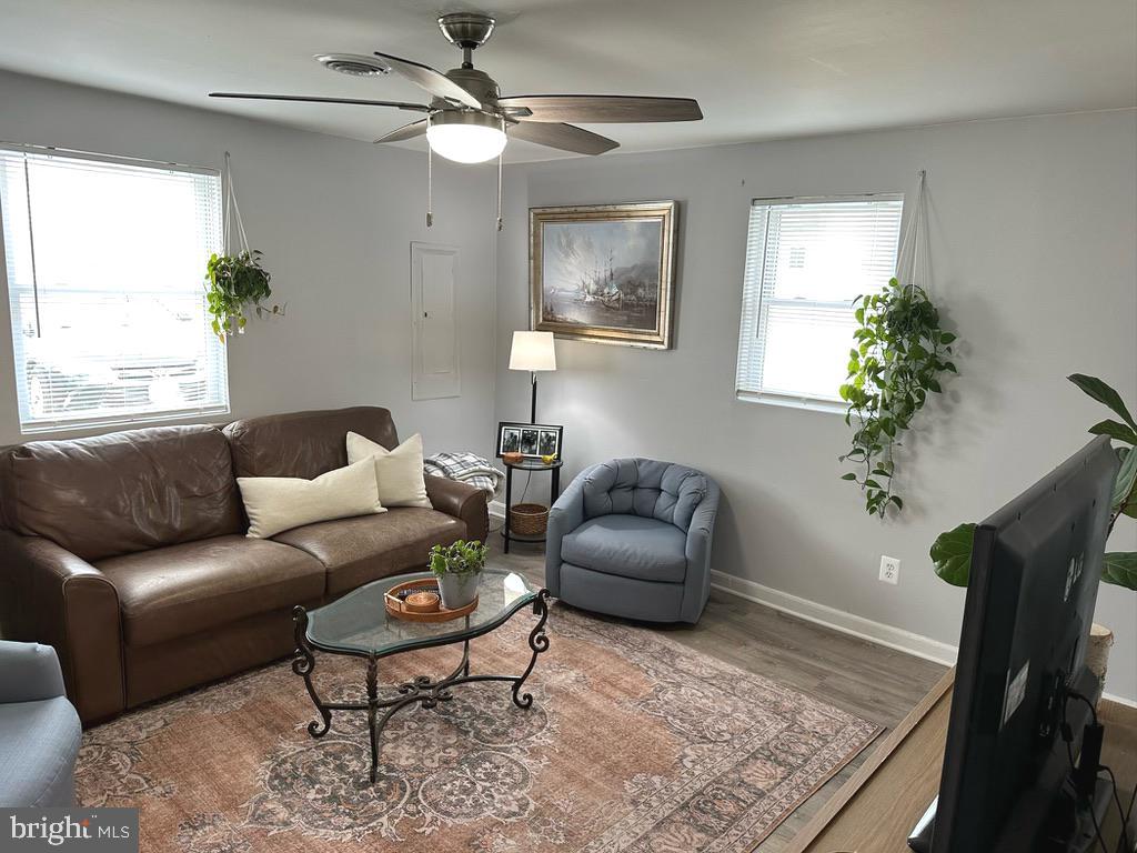 7703 Dover Road Glen Burnie, MD 21060 - Photo 8 of 25 a living room with furniture a chandelier and a rug