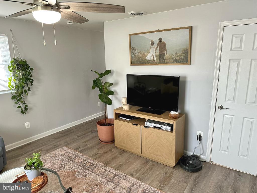 7703 Dover Road Glen Burnie, MD 21060 - Photo 9 of 25 a living room with furniture and a potted plant