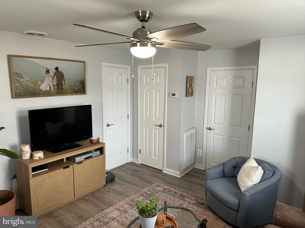7703 Dover Road Glen Burnie, MD 21060 - Photo 10 of 25 a living room with furniture and a flat screen tv