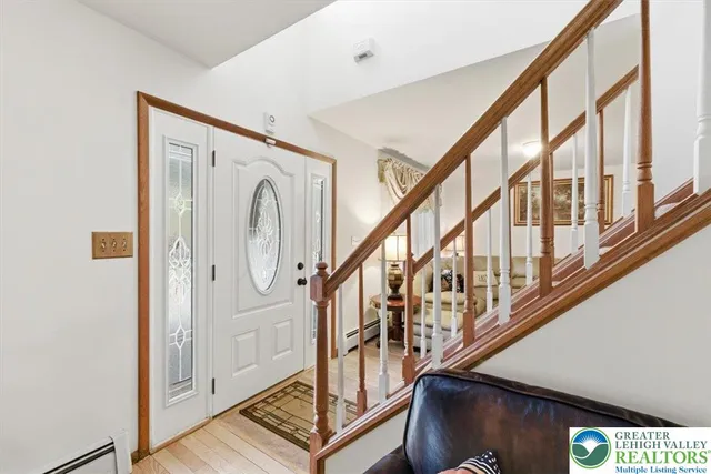 a view of an entryway with wooden floor and door