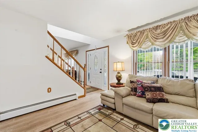 a living room with furniture with a large window