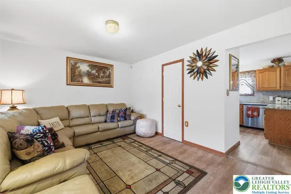 a living room with furniture and a baby crib