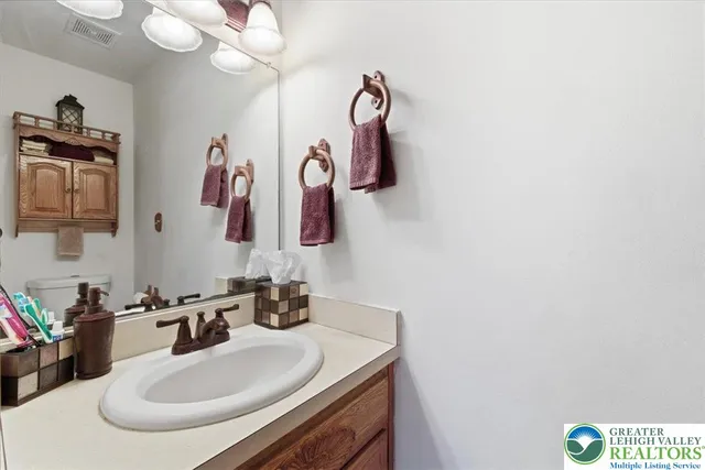 a bathroom with a sink vanity and mirror
