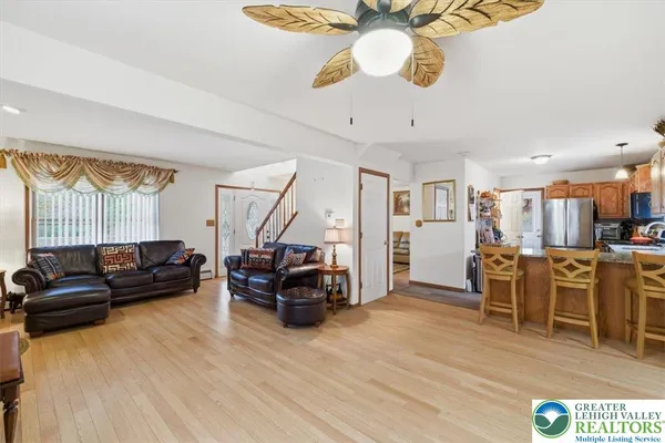 a living room with furniture and kitchen view