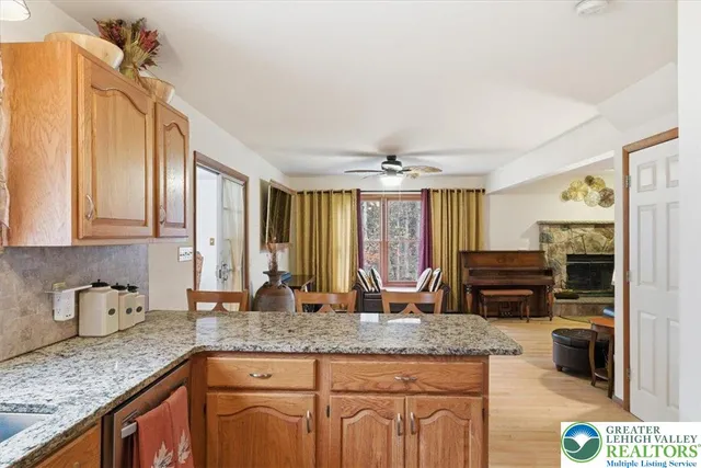 a kitchen with kitchen island granite countertop a sink and refrigerator