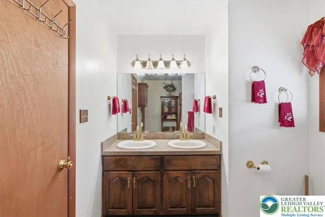 a bathroom with a sink vanity and mirror