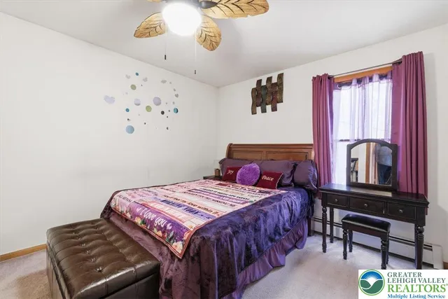 a bedroom with a bed table and chair