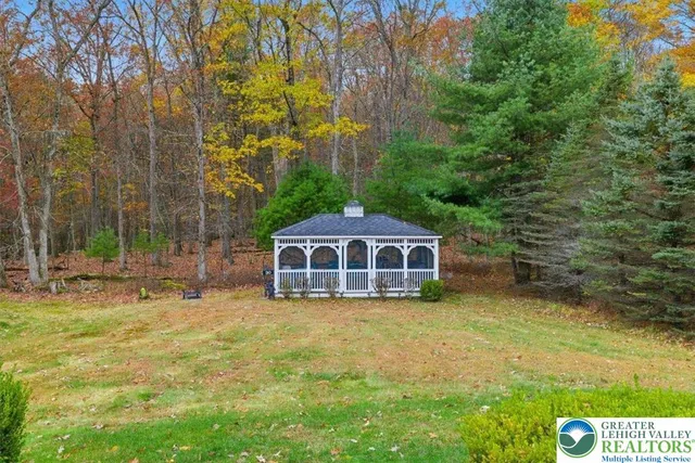 a view of a house with yard and sitting area