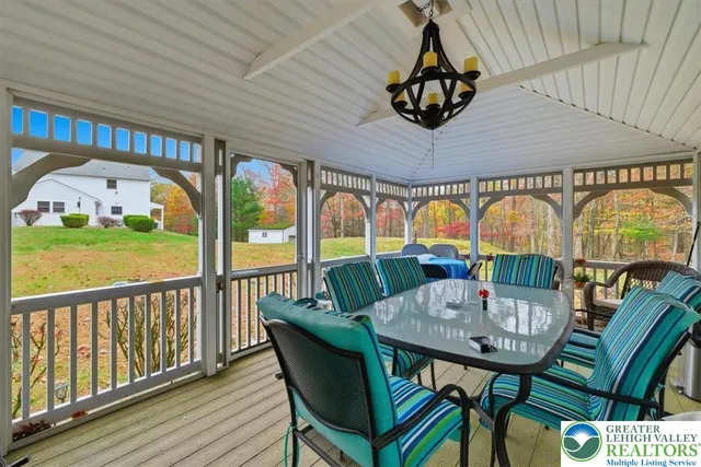 a view of balcony with table and chairs and wooden floor