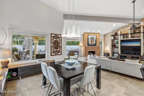 a living room with furniture a flat screen tv and a large window