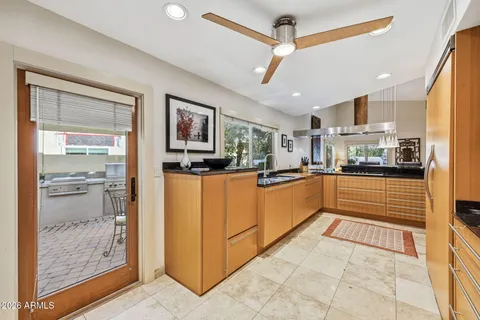 a kitchen with stainless steel appliances granite countertop a refrigerator and a stove top oven