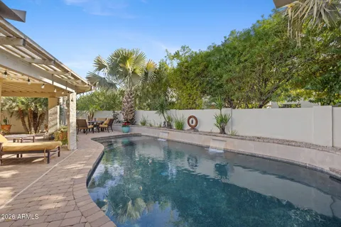 a view of a swimming pool with a lounge chair