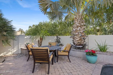 a view of a chairs and table in the patio